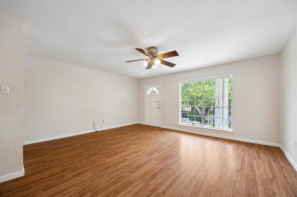 Enjoy your dining area with a chandelier, light walls, and beautiful floors. As you can see this lovely unit features an open layout leading to the kitchen with wooden cabinets. Lots of storage room!