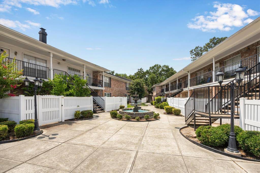 Expansive living room with large front windows provides a lovely view of the mature trees just steps away from your large patio.