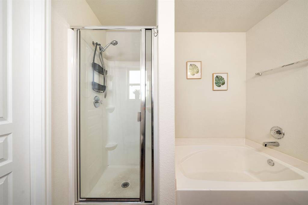 Primary bath with stand up shower and large soaking tub.