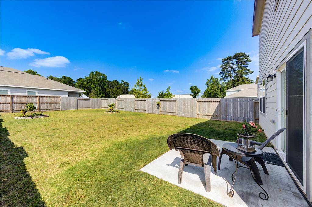 Large backyard with a patio & landscaping