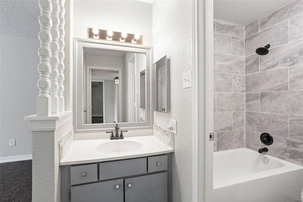 The vanity area is separate from the bathing area.
