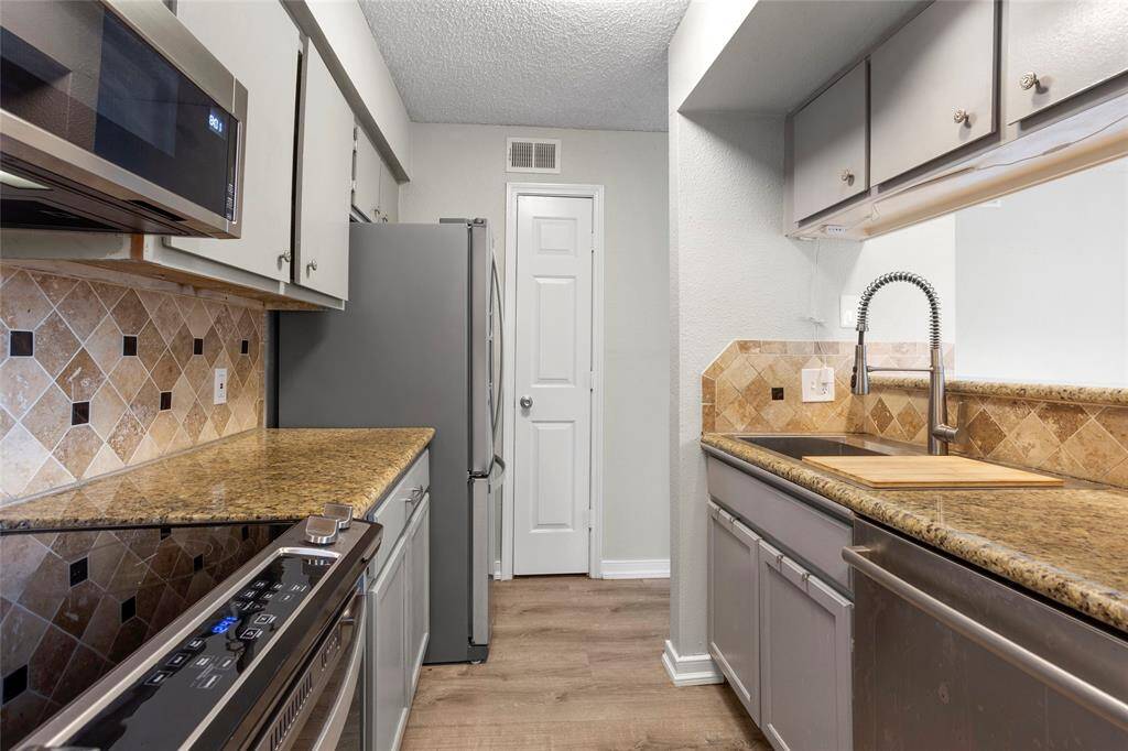 The kitchen has been updated with stainless steel appliances and granite countertops