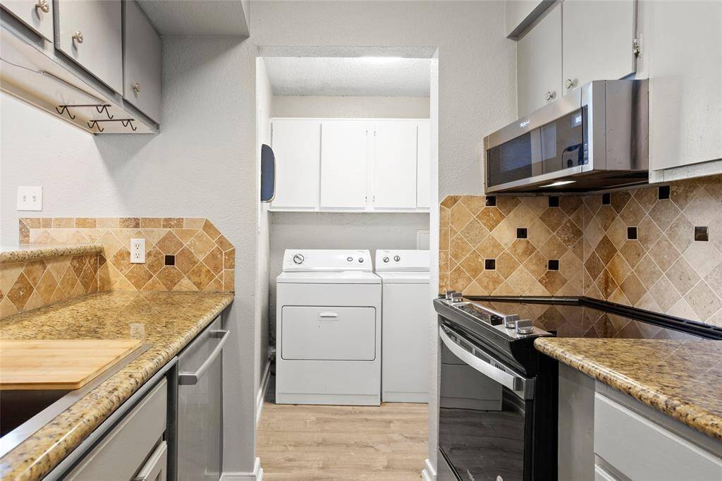 Beyond the kitchen is the in-unit laundry room with FULL SIZE washer & dryer that stay.