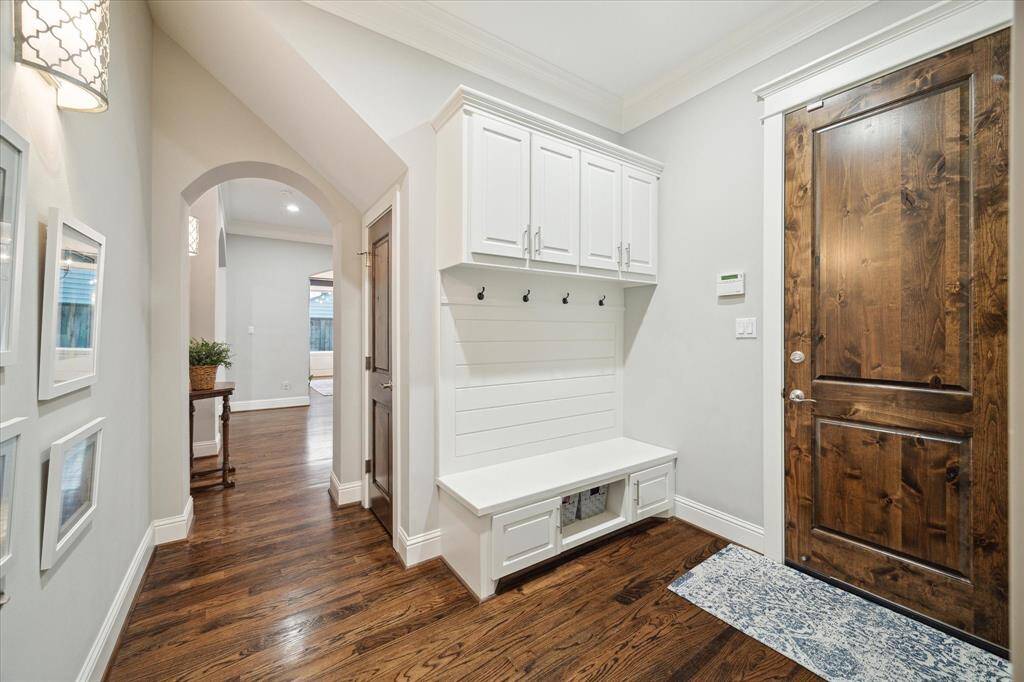 A spacious entry from the garage includes a mudroom with custom built-ins.