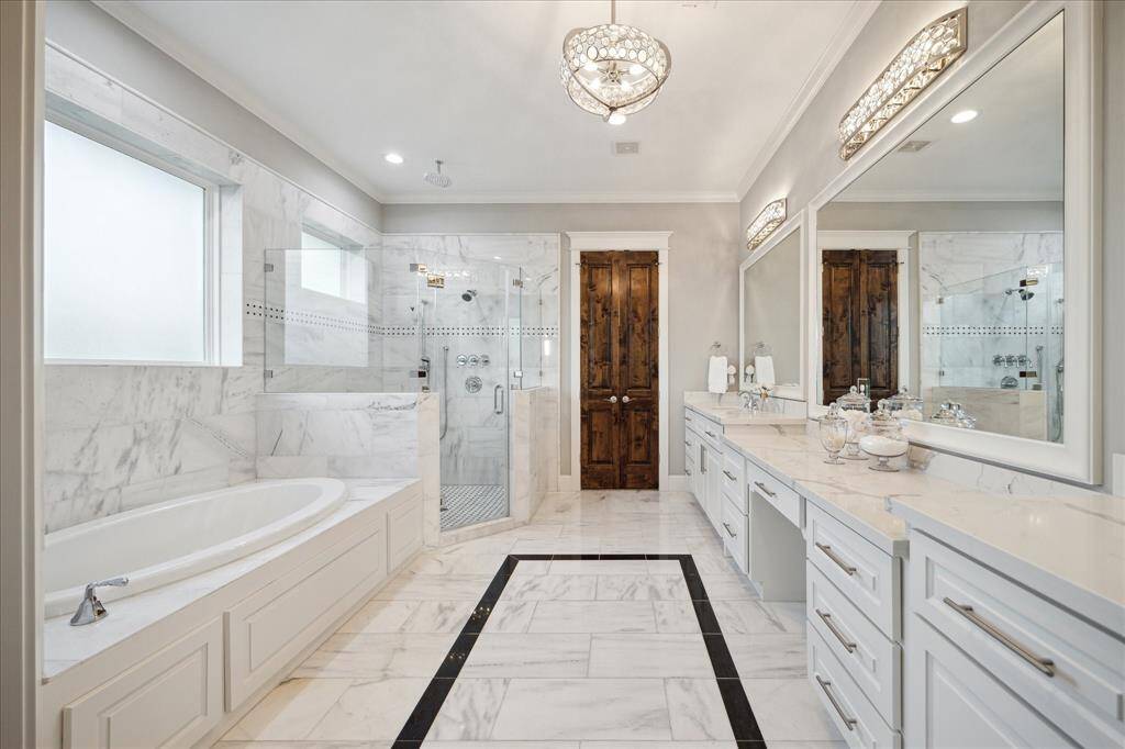 The spa like primary bath offers a Jacuzzi tub, walk-in shower, large vanity with dual sinks, private water closet, and a large walk-in closet.