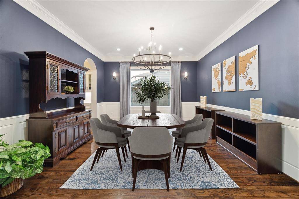 Partial Virtual Staging - CThe dining room features a designer chandelier, recessed lighting, wall sconces, hardwood floors, beautiful trim work, and crown molding.