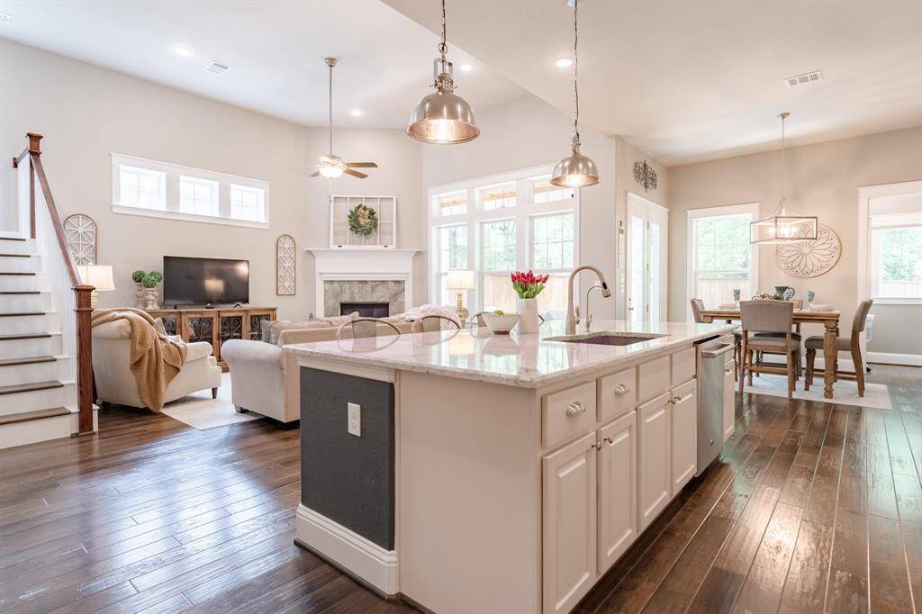 Beautiful engineered hardwood floors span all main living areas on the first floor and extend up the staircase, offering a cohesive, stylish, and low-maintenance finish throughout the home.