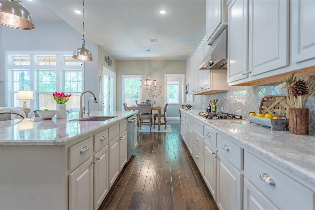Beautifully designed kitchen featuring quartz counters, a premium sink upgrade, and spacious bar seating for casual dining.