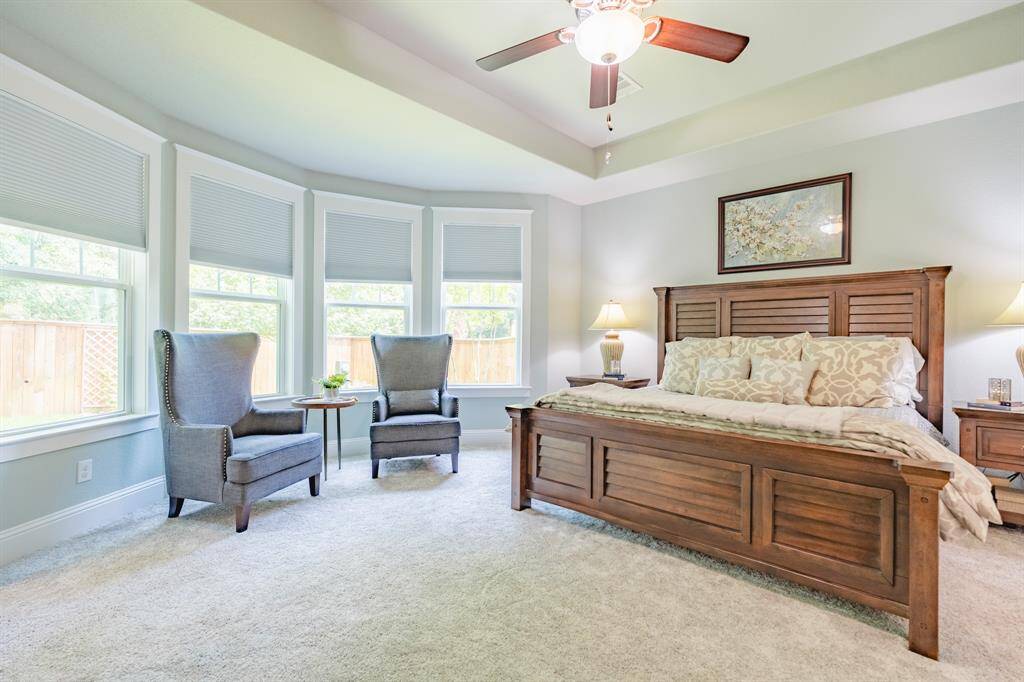 Spacious primary retreat featuring extended bay windows that flood the room with natural light—an ideal space for a cozy reading nook or private sitting area.