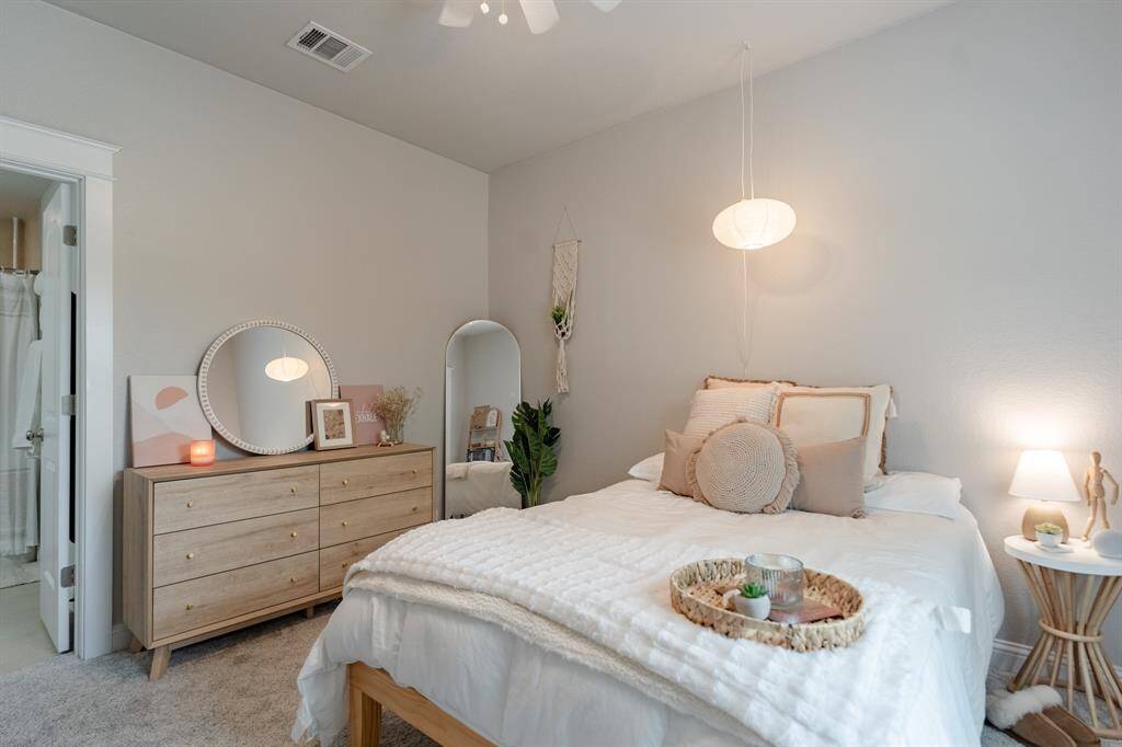 One of two upstairs bedrooms, this private suite features its own ensuite bathroom and a spacious walk-in closet.