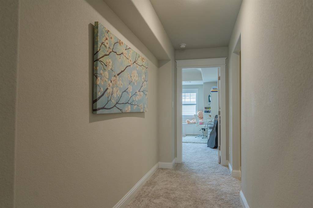 Wide hallway leading to the spacious game room/media room—creating an open, airy flow and easy access to entertainment space.