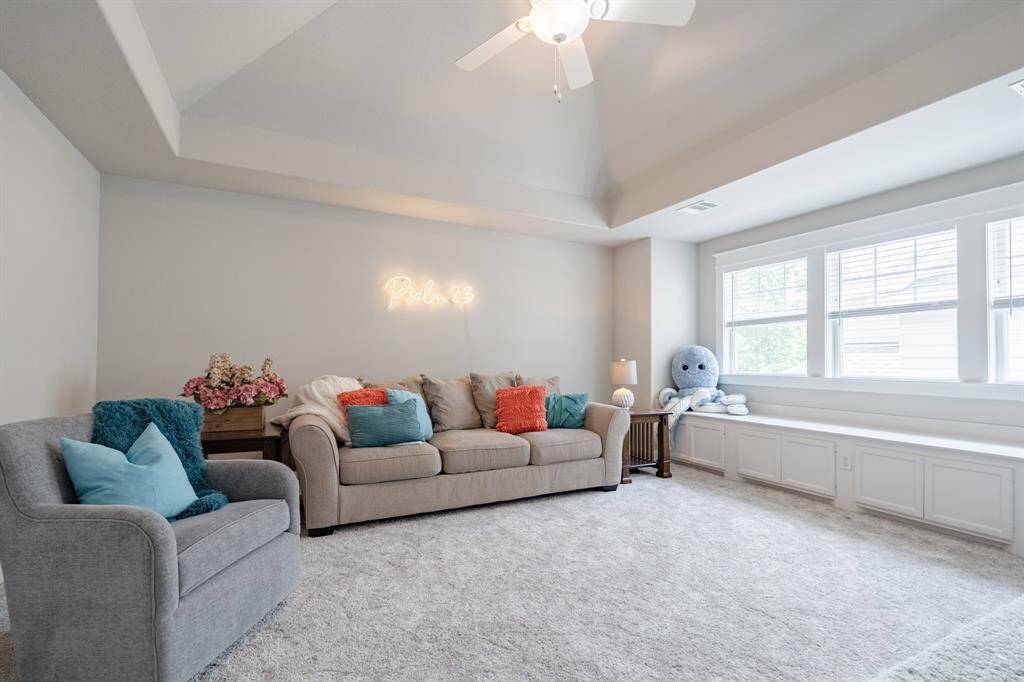 Spacious game room/media room featuring a large window seat that doubles as storage—perfect for stowing games, toys, crafts, and more, while offering a cozy spot to relax.