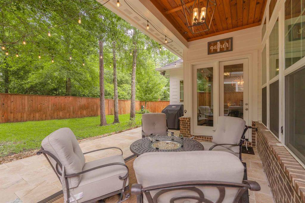 Beautiful patio featuring an upgraded light fixture and stunning wood ceiling—creating a perfect space for outdoor entertaining and relaxation.
