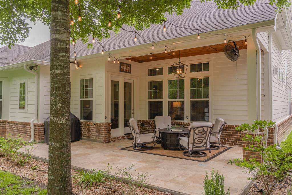 Extended tile patio providing ample space for seating, grilling, and entertaining—ideal for outdoor relaxation and gatherings.