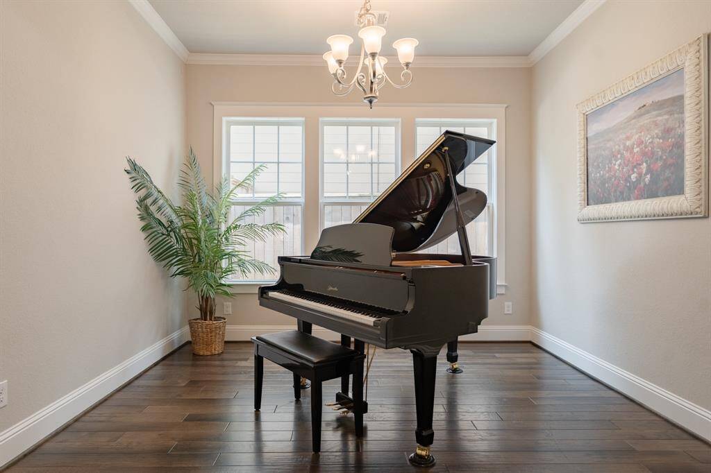 Elegant formal dining room, currently showcased as a music room with a stunning baby grand piano.