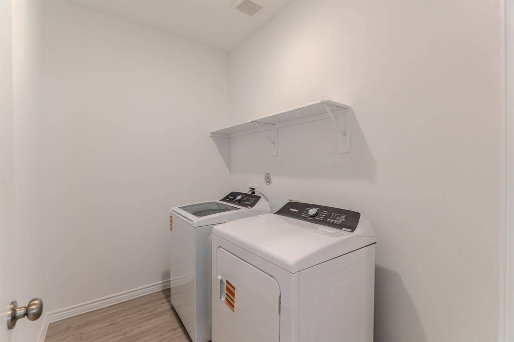 Spacious laundry room with shelving