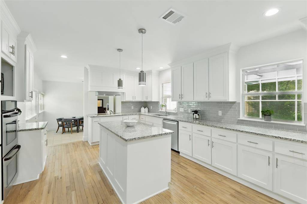 Huge stunning island kitchen with double ovens, 2 windows and all the right selections