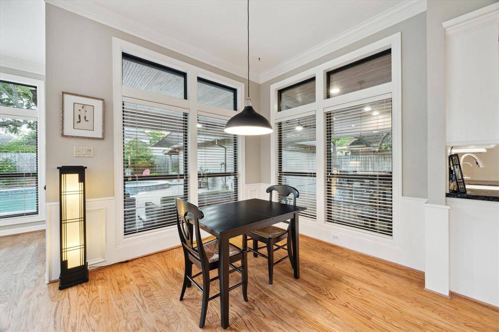The breakfast room is surrounded by windows and offers a great view of the pool and covered patio area.