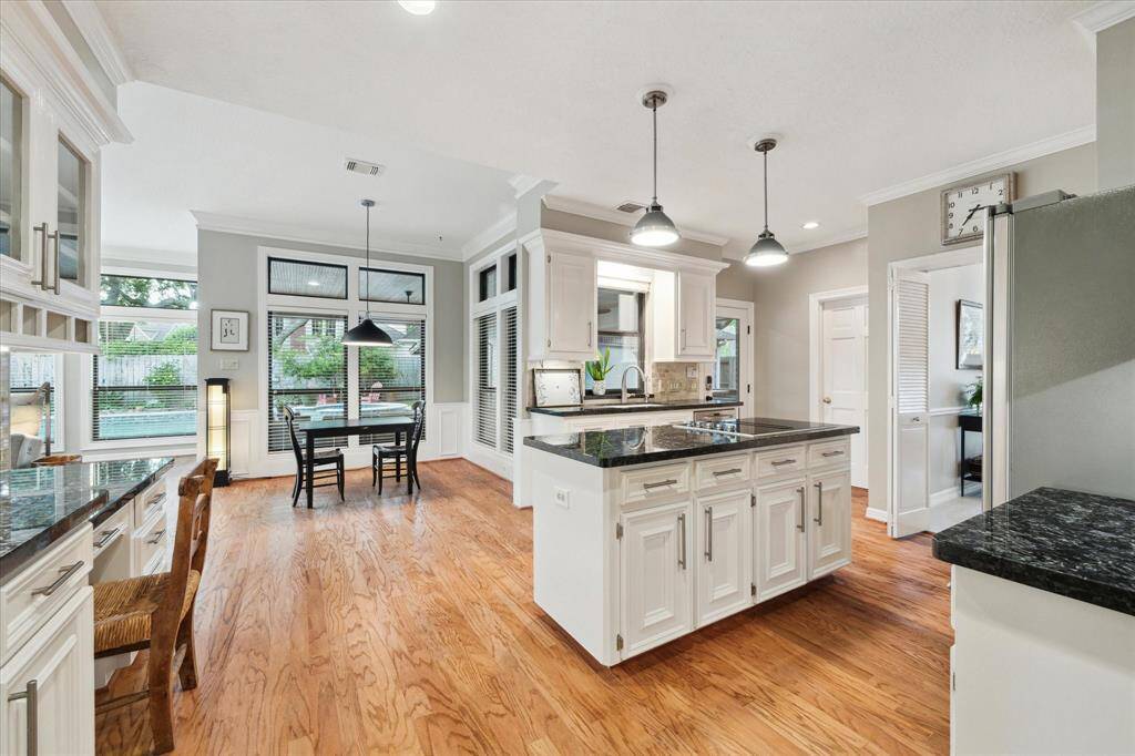 The kitchen offers granite countertops, a center island and a chef's desk.