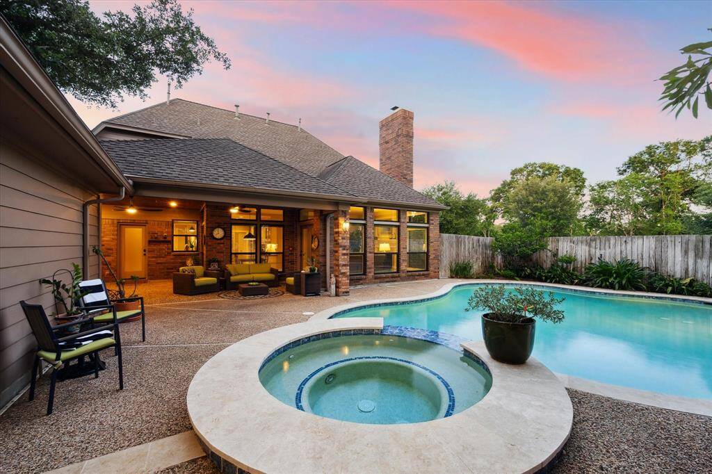 The backyard offers something for everyone with a large covered patio, a pool, and a spa.