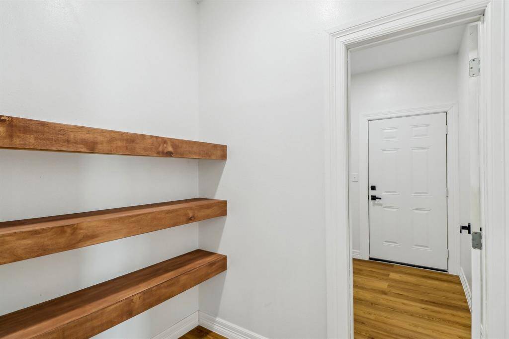Notice this hallway with built-in wood shelving, perfect for putting home decor that caters to your style.