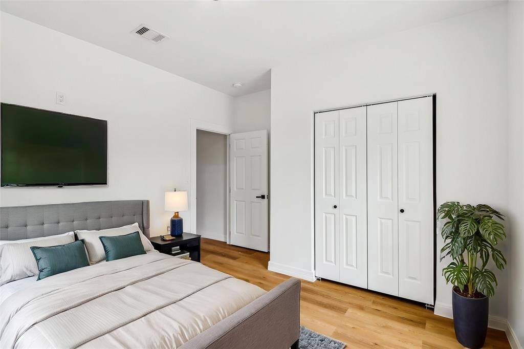This inviting bedroom offers a tranquil retreat, featuring abundant natural light and ample space.