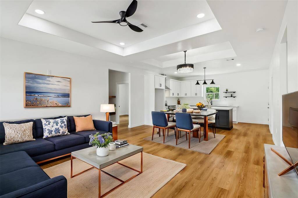 Gleaming hardwood floors flow throughout, complementing the pristine white walls and offering a versatile backdrop for your personal style.