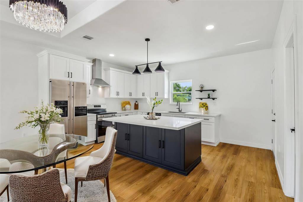 Step into this bright and modern kitchen, featuring the dining room as well.