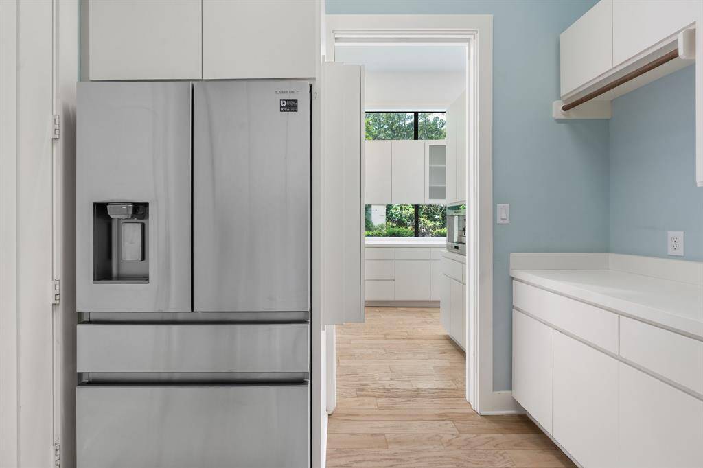 Entry to the spacious laundry room with mega storage and 2nd refrigerator.