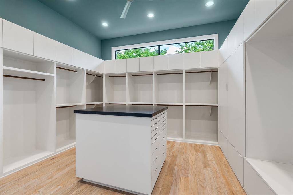 This shows only 1/2 of the custom designed primary closet! The high windows insure nice natural light here.