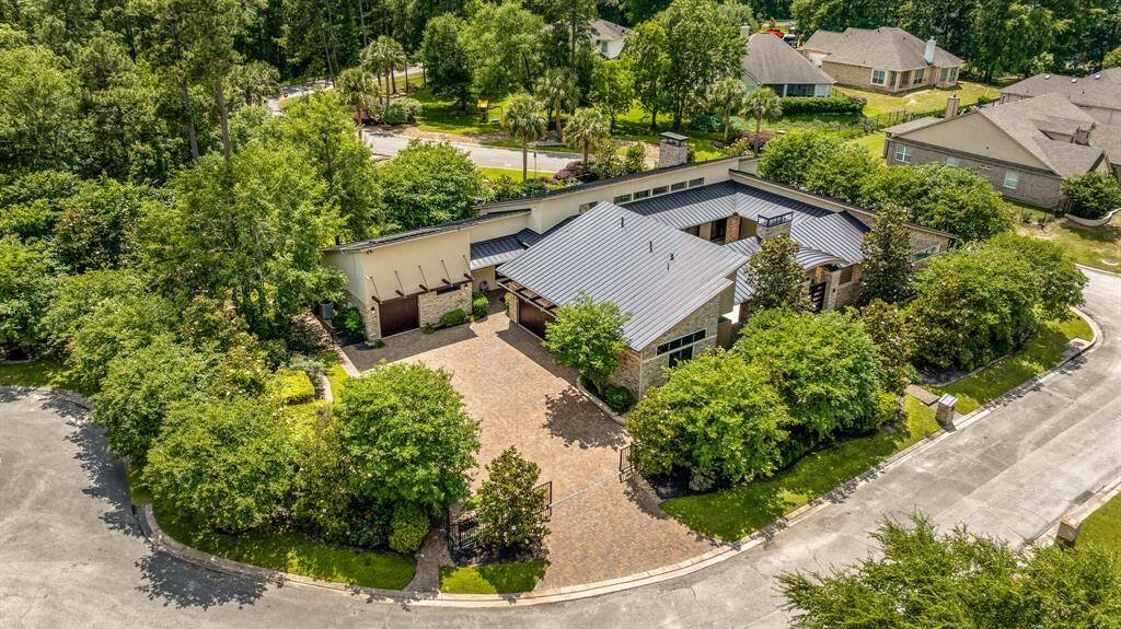 All 3 lots are iron fenced and a private gate to the triple wide driveway gives access to two separate garage areas!