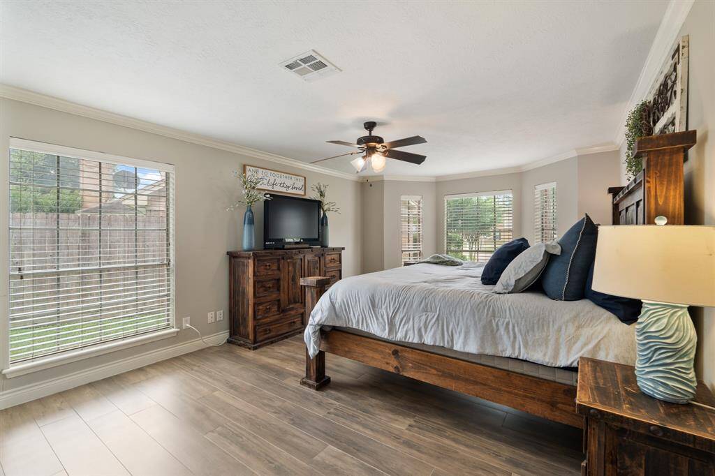 The primary bedroom welcomes you with bright natural light, an upgraded bay window with a relaxing sitting area, and the perfect view of the serene yard. It easily fits a king size bed plus furniture!
