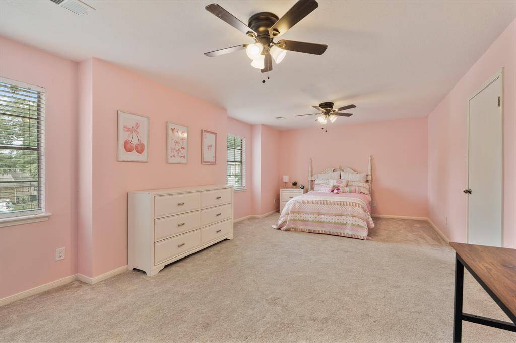 Bright and inviting, this oversized secondary bedroom offers plenty of room for relaxation and personalization, making it the perfect retreat for family or guests. It's complete with plush carpet two ceiling fans, and a spacious closet.