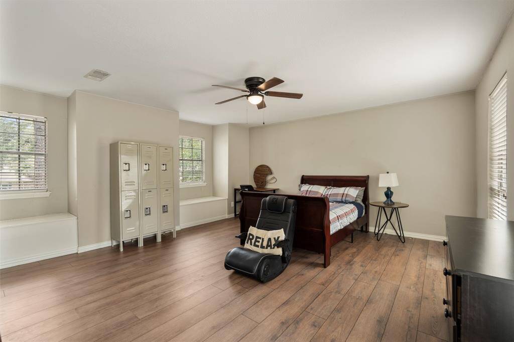 This secondary bedroom is complete with 2 window seats, perfect for a reading nook! This room has been updated with neutral paint, wood look flooring, and a ceiling fan.