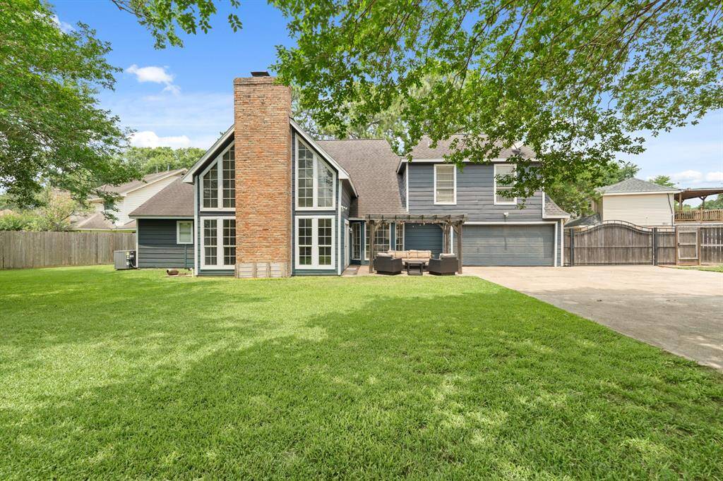 Step outside to enjoy the expansive backyard, complete with a covered patio and extended concrete area — the perfect setup for outdoor dining, lounging, or weekend barbecues.