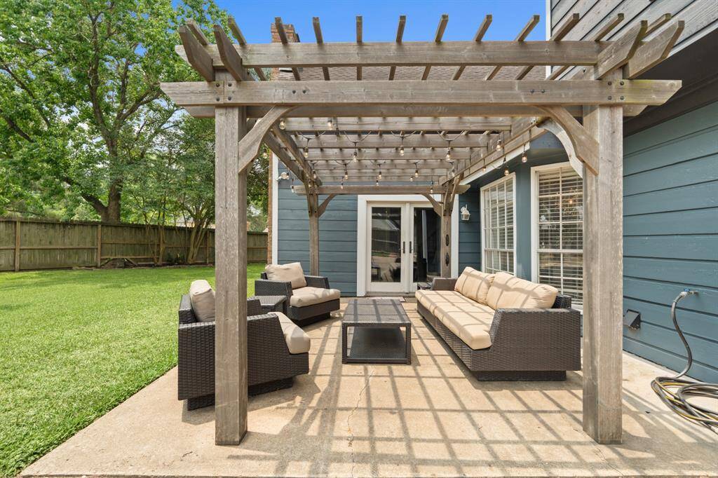 Outdoor living at its finest! This custom pergola and concere patio is perfect for relaxing or entertaining year-round. It connects to the living area through the glass doors, making great for entertaining!