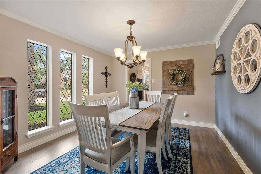 Make memories gathered around the table with your family and friends! This dining room features an accent wall, crown molding, large windows, and a beautiful chandelier! It connects directly to the kitchen, making it easy to entertain!