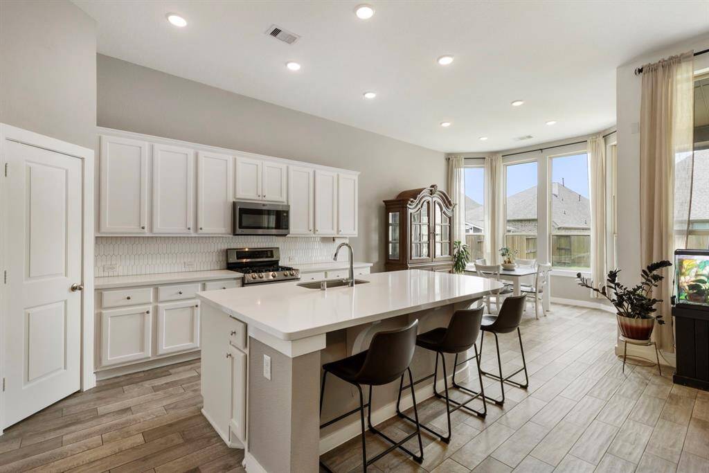 The cook in the family will love the convenient corner pantry, double oven gas range and plenty of overhead recessed lighting.