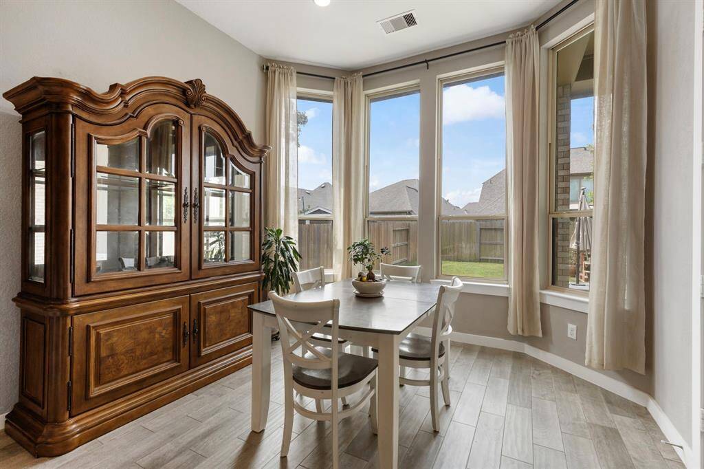 The dining area is framed by picture windows - an ideal spot to enjoy your morning coffee!