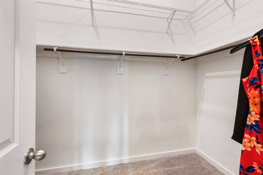 The generous size primary closet offers plenty of hanging space and storage.