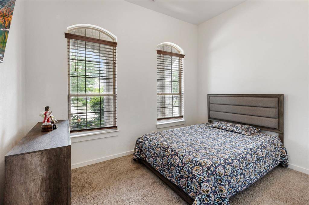 Secondary bedroom #1 is located at the front of the home with wood blinds and nice walk in closet.