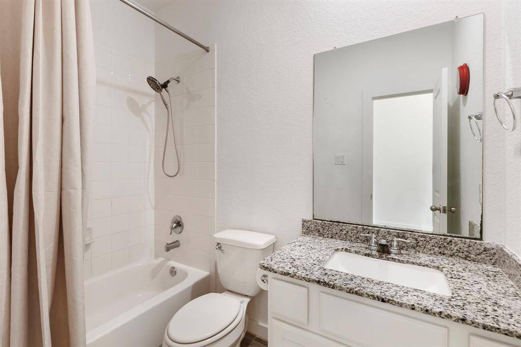 A full bath is located in-between secondary bedrooms #1 and #2 with granite counters and tub/shower combination with tile surround.