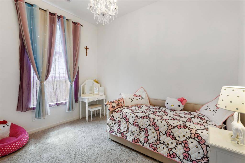Secondary bedroom #2 is nice in size and offers a stylish light fixture!