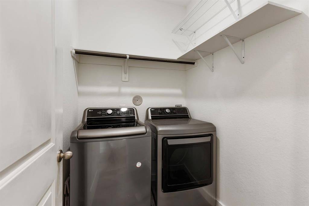 The utility room is situated near the garage with hanging space and shelving. Clothes washer and dryer will remain in the home!