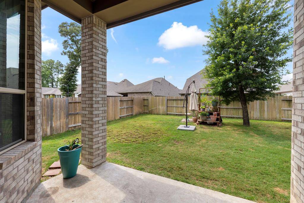 Off the dining area, there is a covered patio - with a view of the large backyard.