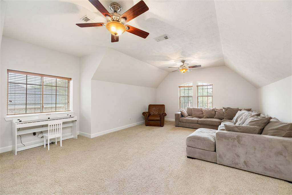 This spacious upstairs game room offers endless possibilities for fun and relaxation, with plush carpeting, two ceiling fans, and abundant natural light. Whether used as a play area, media room, or second living space, it’s the perfect spot for gathering and unwinding.