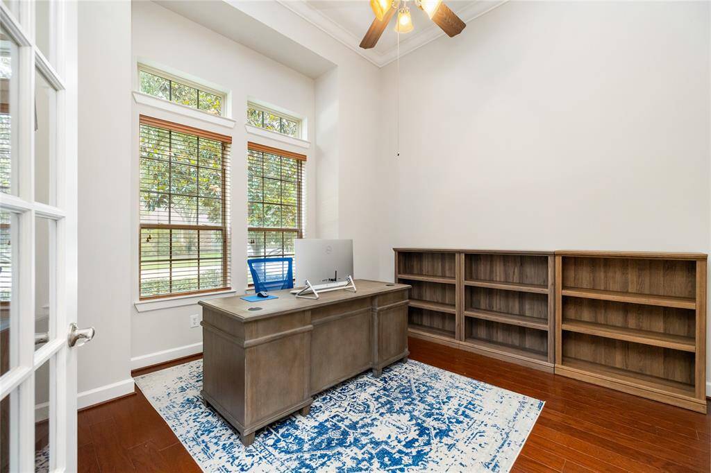 This bright and inviting study features soaring ceilings, rich hardwood floors, and a wall of windows that flood the space with natural light. French doors offer added privacy, and there’s plenty of room for bookshelves, file storage, or a cozy reading nook—perfect for working from home or quiet focus.