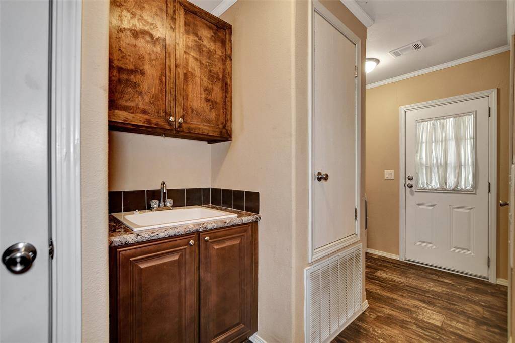 laundry room with extra sink and storage