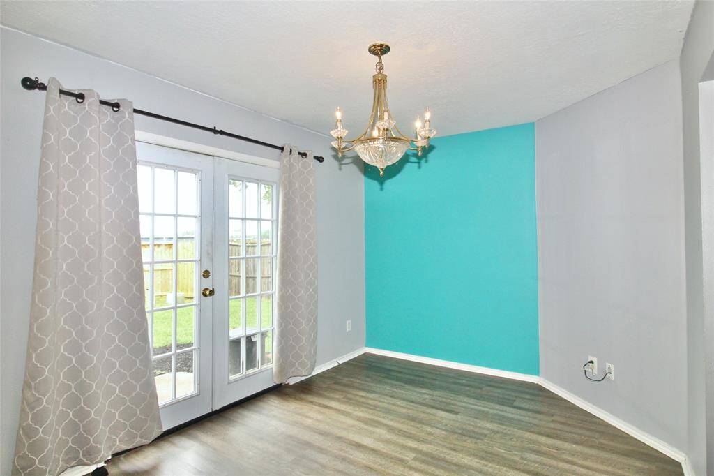 The formal dining room features french doors overlooking the backyard.