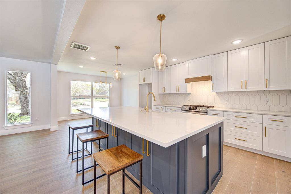 Step into a chef’s dream in this completely remodeled island kitchen, where every detail has been thoughtfully curated for both function and style. Crisp white shaker cabinetry stretches across the space, providing abundant storage and a clean, timeless aesthetic.